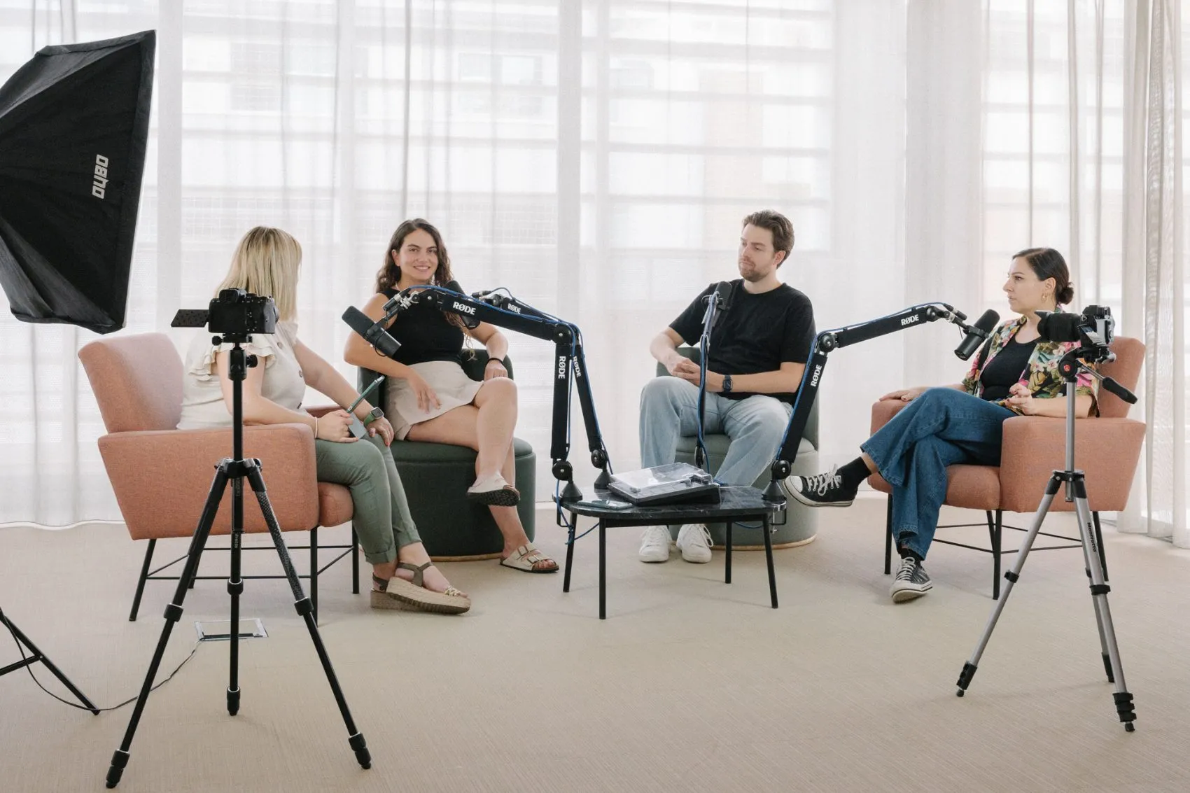 Four people recording a podcast in a Memento studio