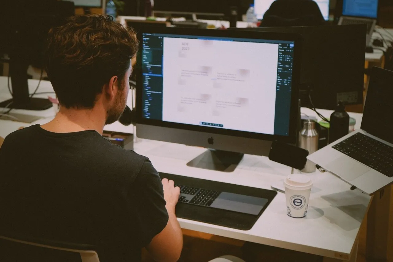A producer working at a computer in the Memento office
